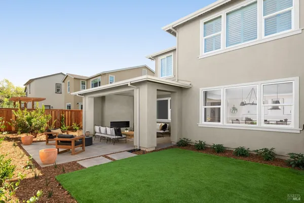 a view of a house with backyard porch and sitting area