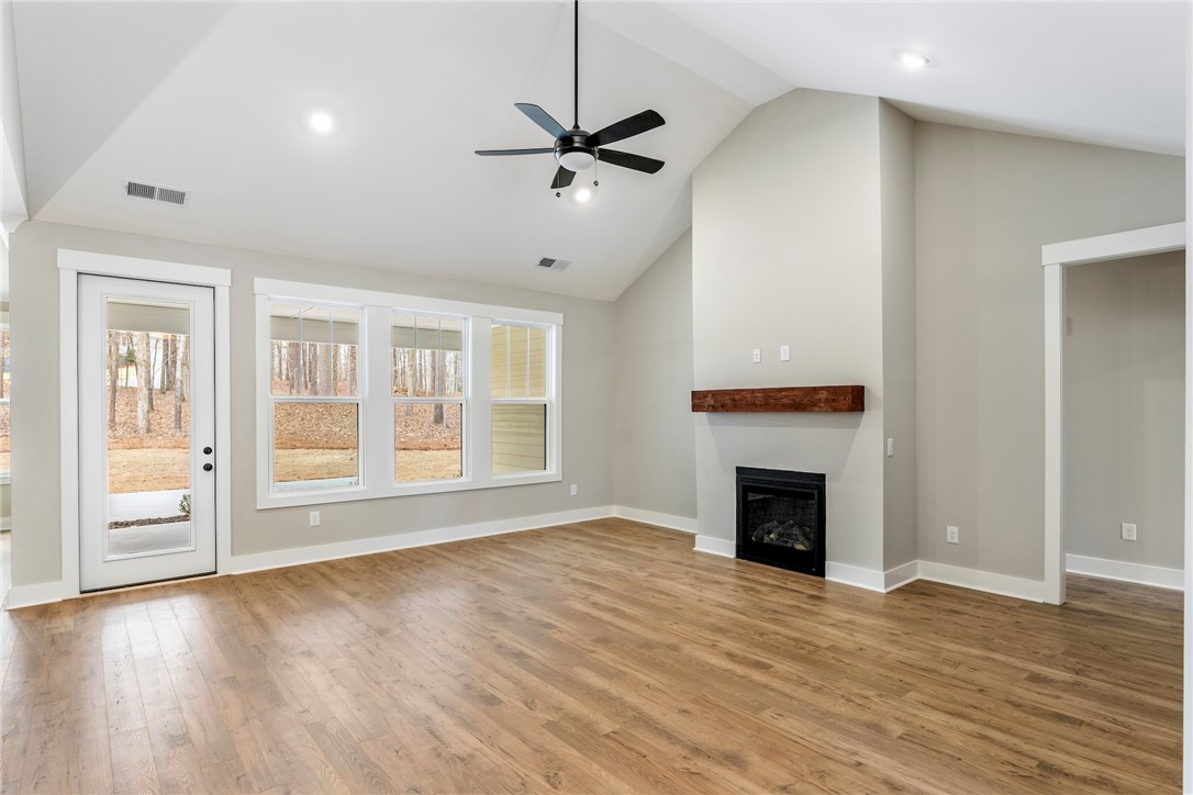 117 Falcon Crest Way Pickens, SC 29671 - Photo 3 of 6 This inviting living room boasts vaulted ceilings and a cozy fireplace, perfect for gatherings.