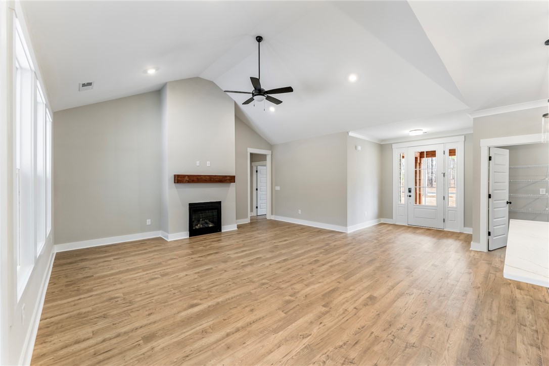 117 Falcon Crest Way Pickens, SC 29671 - Photo 4 of 6 This airy living space features abundant natural light, a cozy fireplace, and direct outdoor access.