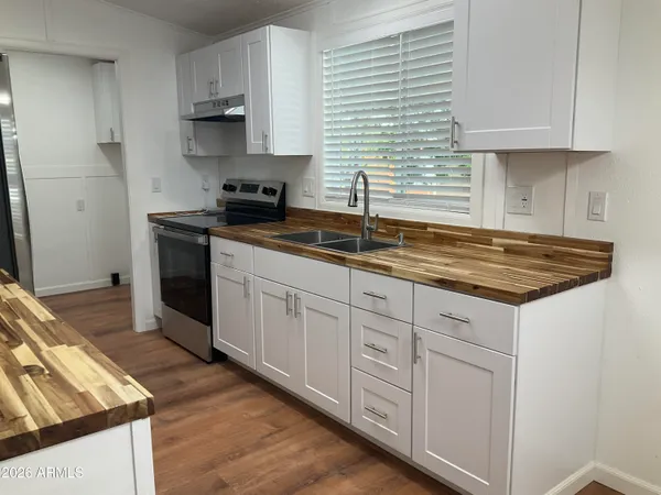 a kitchen with stainless steel appliances granite countertop a refrigerator and a stove