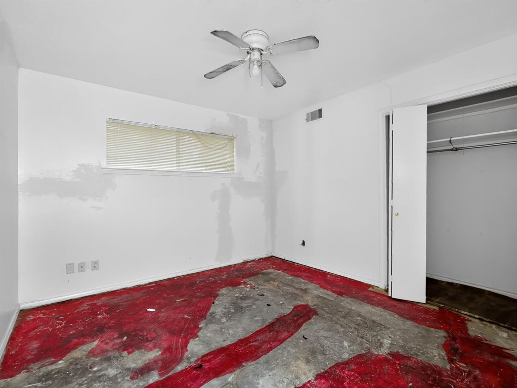 3216 Rotan Lane Dallas, TX 75229 - Photo 16 of 28 a bedroom with a bed and a chandelier fan