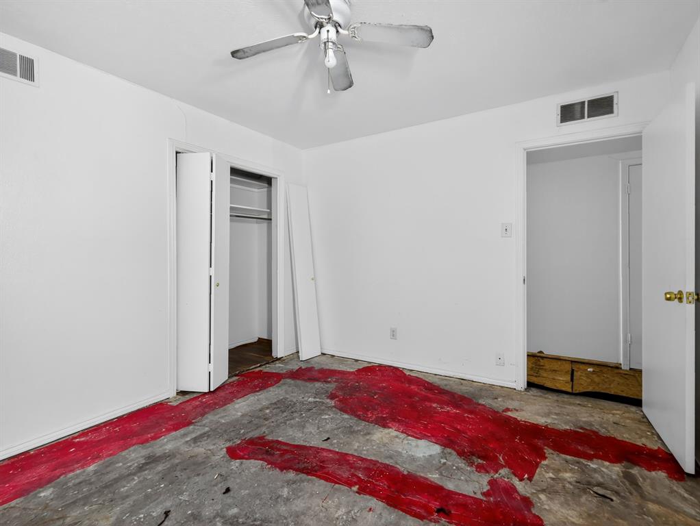 3216 Rotan Lane Dallas, TX 75229 - Photo 17 of 28 a bedroom with a bed and a chandelier fan