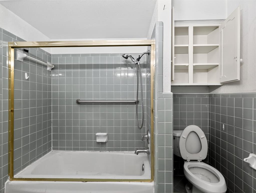 3216 Rotan Lane Dallas, TX 75229 - Photo 20 of 28 a bathroom with a granite countertop bathtub shower