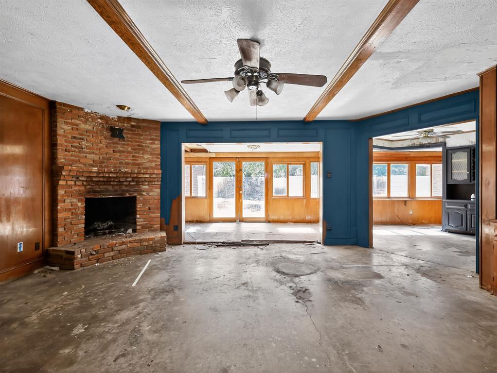 3216 Rotan Lane Dallas, TX 75229 - Photo 2 of 28 a view of an empty room with a fireplace and a window