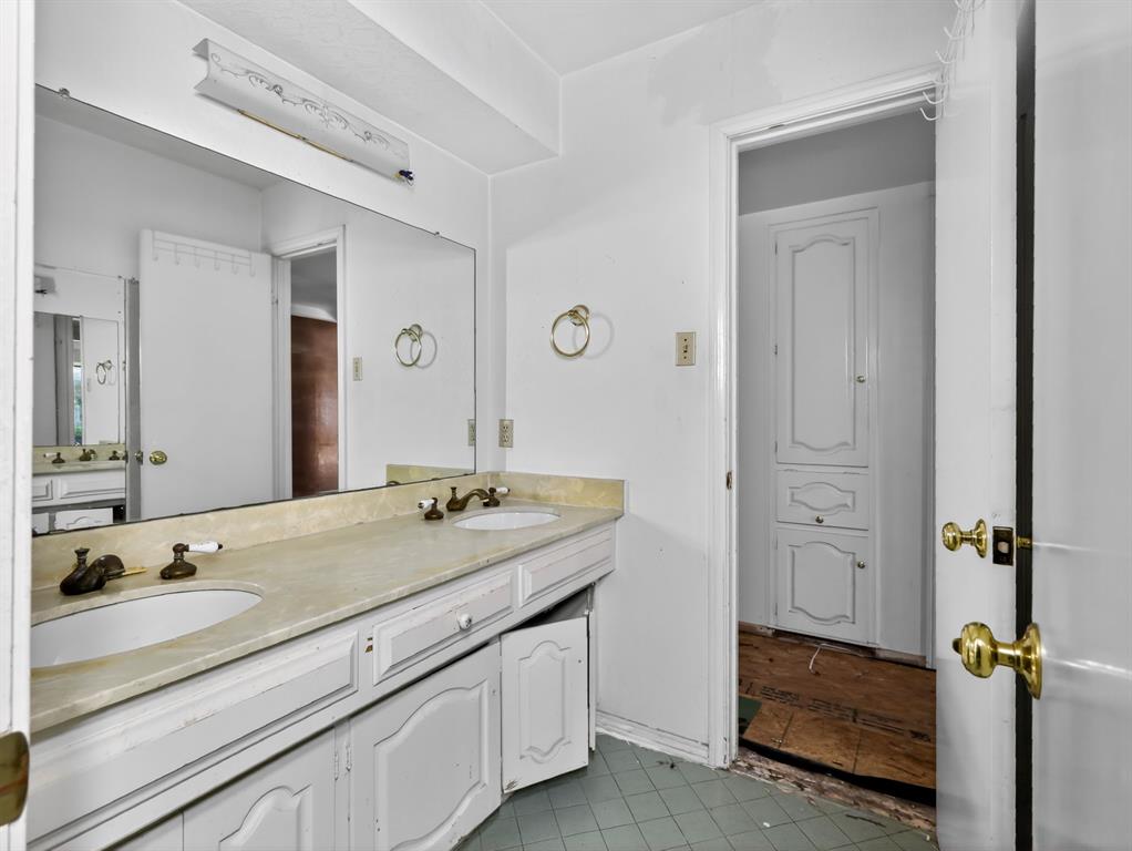 3216 Rotan Lane Dallas, TX 75229 - Photo 21 of 28 a bathroom with a granite countertop sink and a mirror