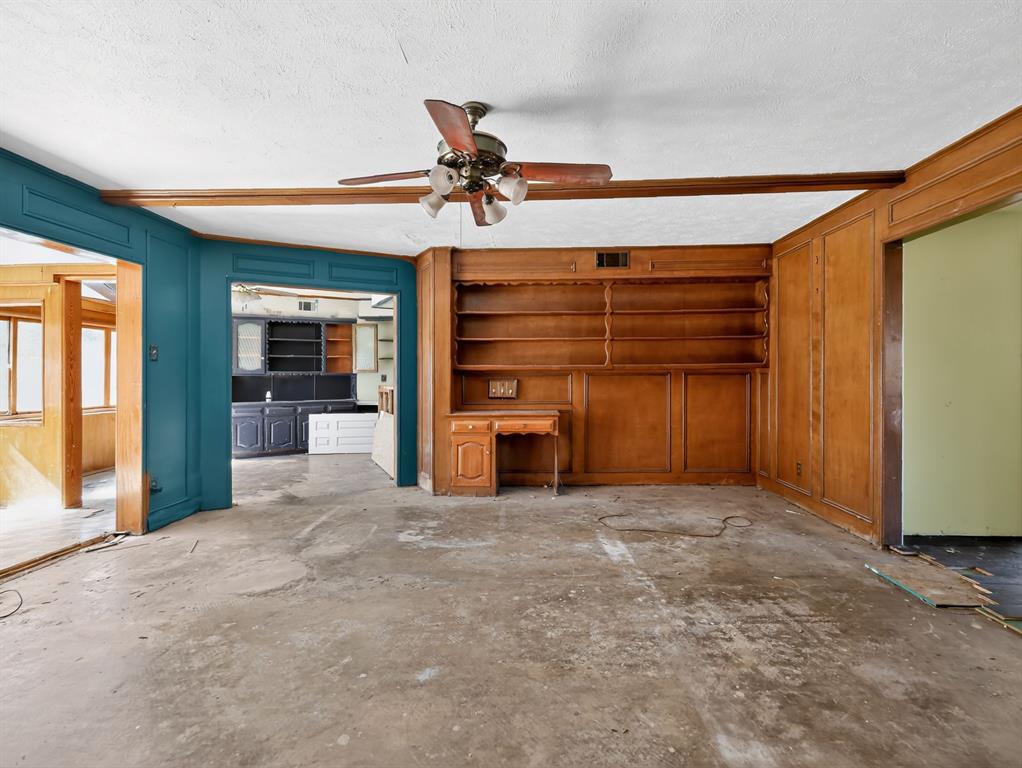 3216 Rotan Lane Dallas, TX 75229 - Photo 3 of 28 a view of a livingroom with a staircase and a kitchen space