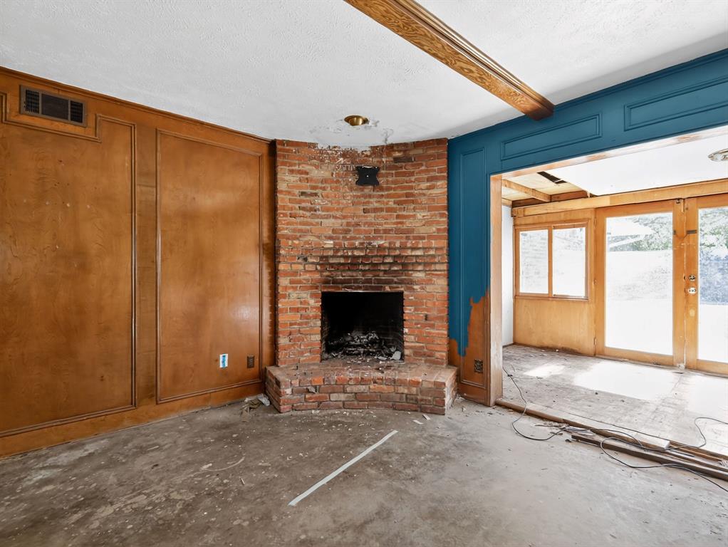3216 Rotan Lane Dallas, TX 75229 - Photo 5 of 28 a view of an empty room with a fireplace and a window