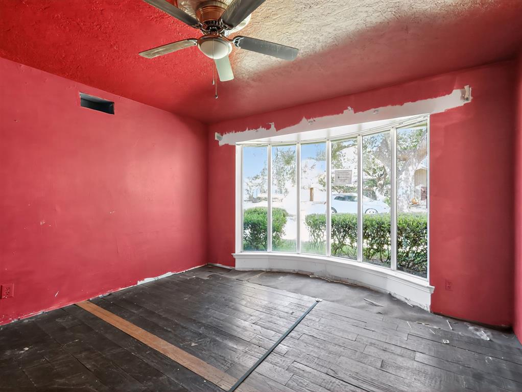 3216 Rotan Lane Dallas, TX 75229 - Photo 6 of 28 a view of empty room with wooden floor and fan
