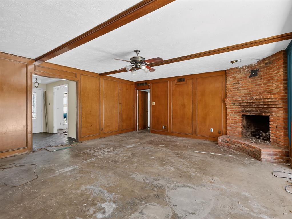3216 Rotan Lane Dallas, TX 75229 - Photo 8 of 28 a view of a livingroom with a fireplace and a ceiling fan