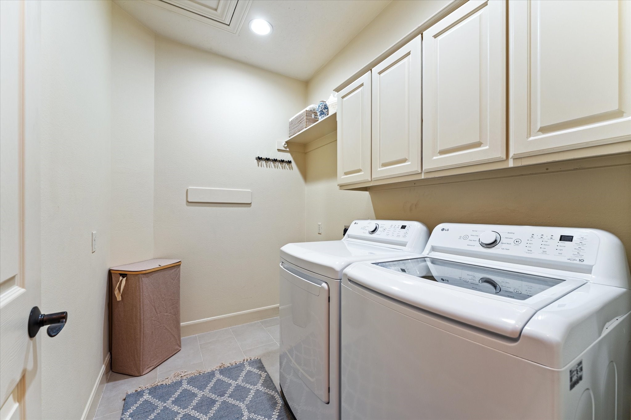 28331 Hollow Springs Lane Spring, TX 77386 - Photo 24 of 49 Spacious laundry room featuring ample cabinet storage and dedicated space for a refrigerator.