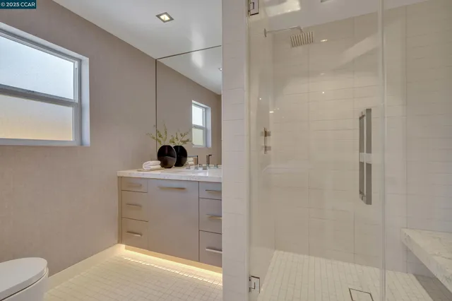 a bathroom with a tub sink and mirror