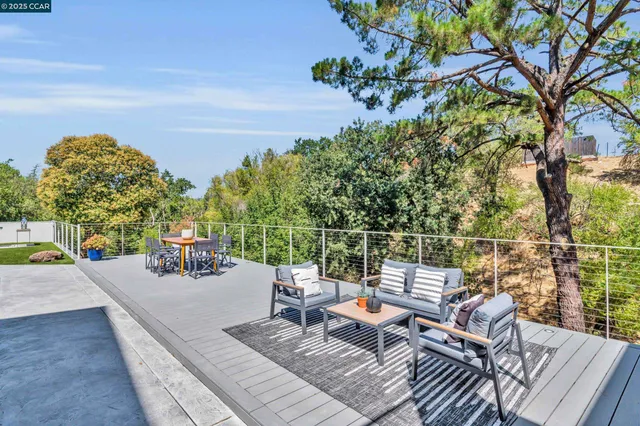 a view of backyard with outdoor seating and trees