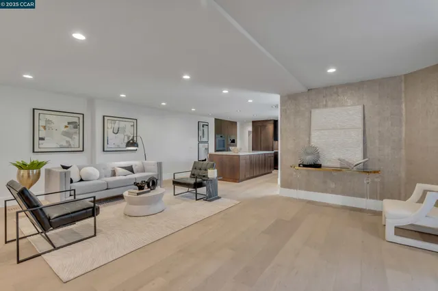 a living room with furniture and view of kitchen