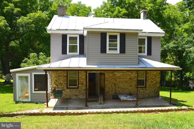 a view of a house with backyard porch and furniture