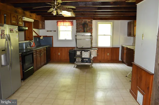 a kitchen with refrigerator and window