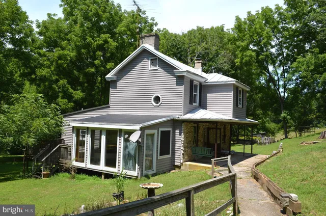 a view of front door of house with a yard