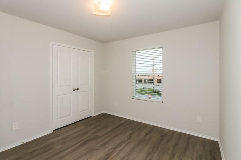 21626 Mamba Way Houston, TX 77073 - Photo 7 of 12 an empty room with wooden floor and windows