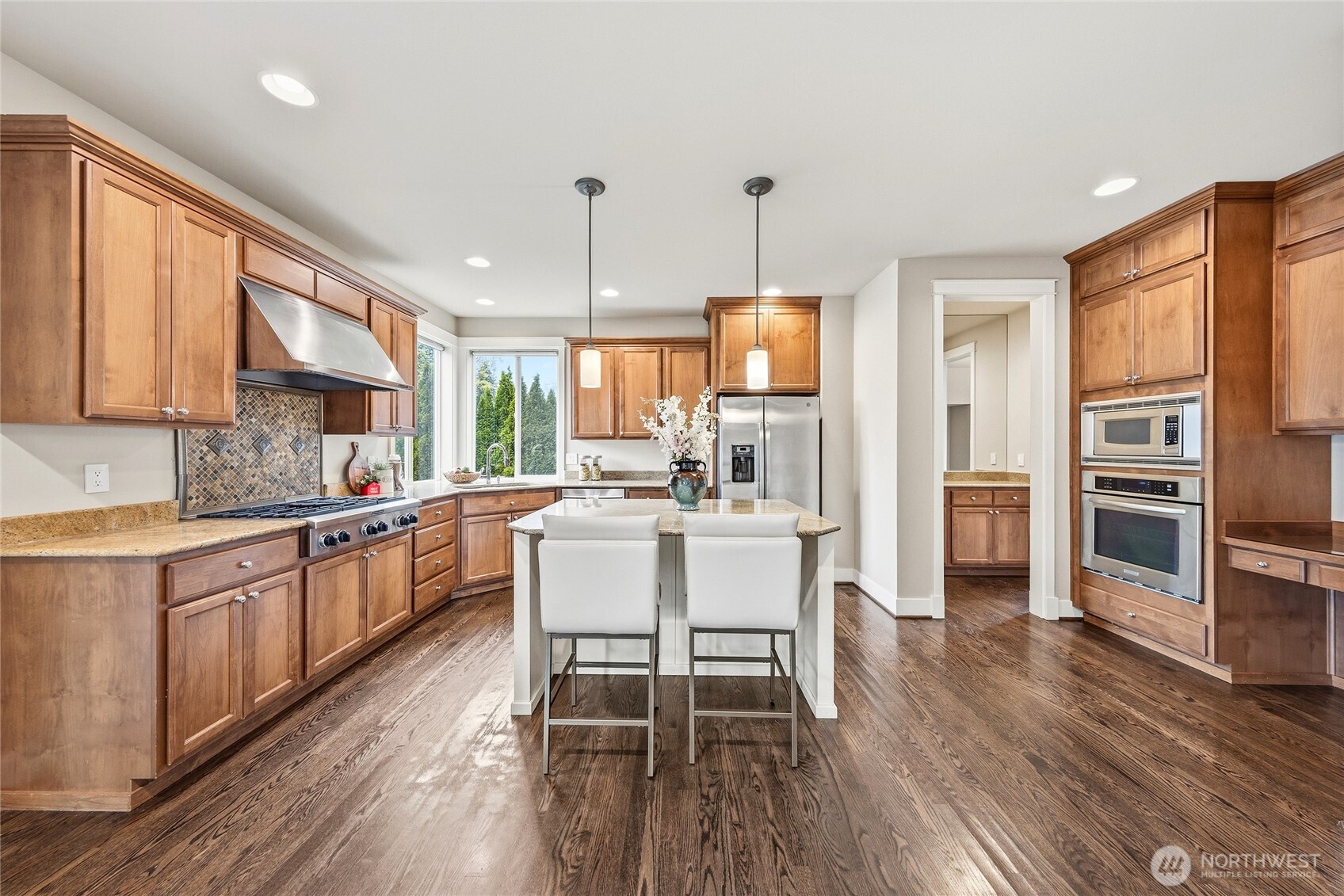 3514 184th Place Southeast Bothell, WA 98012 - Photo 4 of 39 a kitchen with stainless steel appliances a dining table chairs sink and wooden floor
