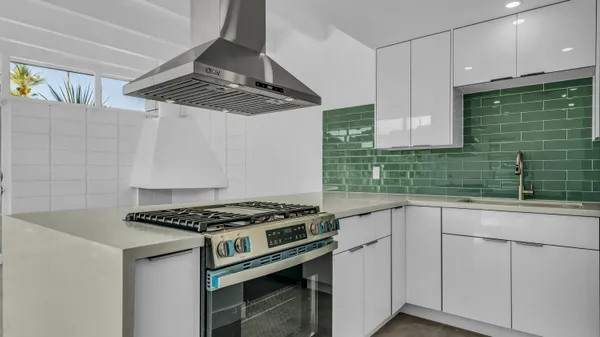 a kitchen with cabinets and appliances