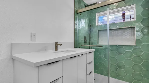view of a bathroom with a sink and a mirror
