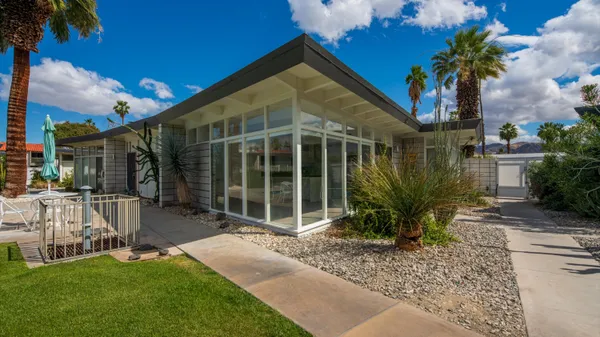 a house view with a sitting space and garden