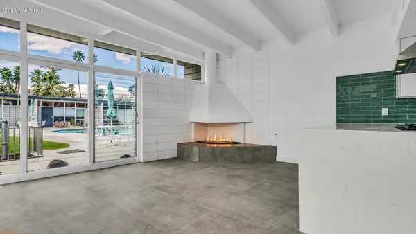 a view of an empty room and floor to ceiling window