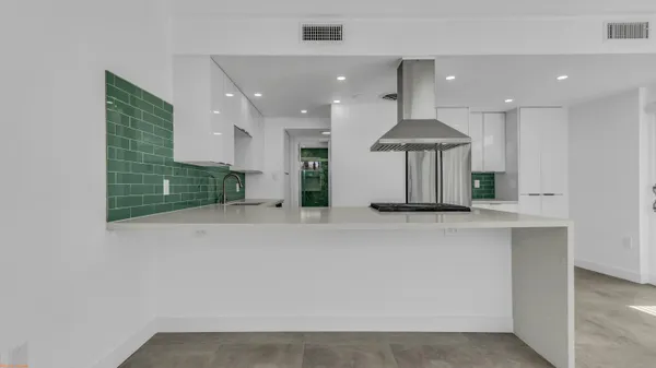a view of kitchen with stainless steel appliances granite countertop cabinets and stove