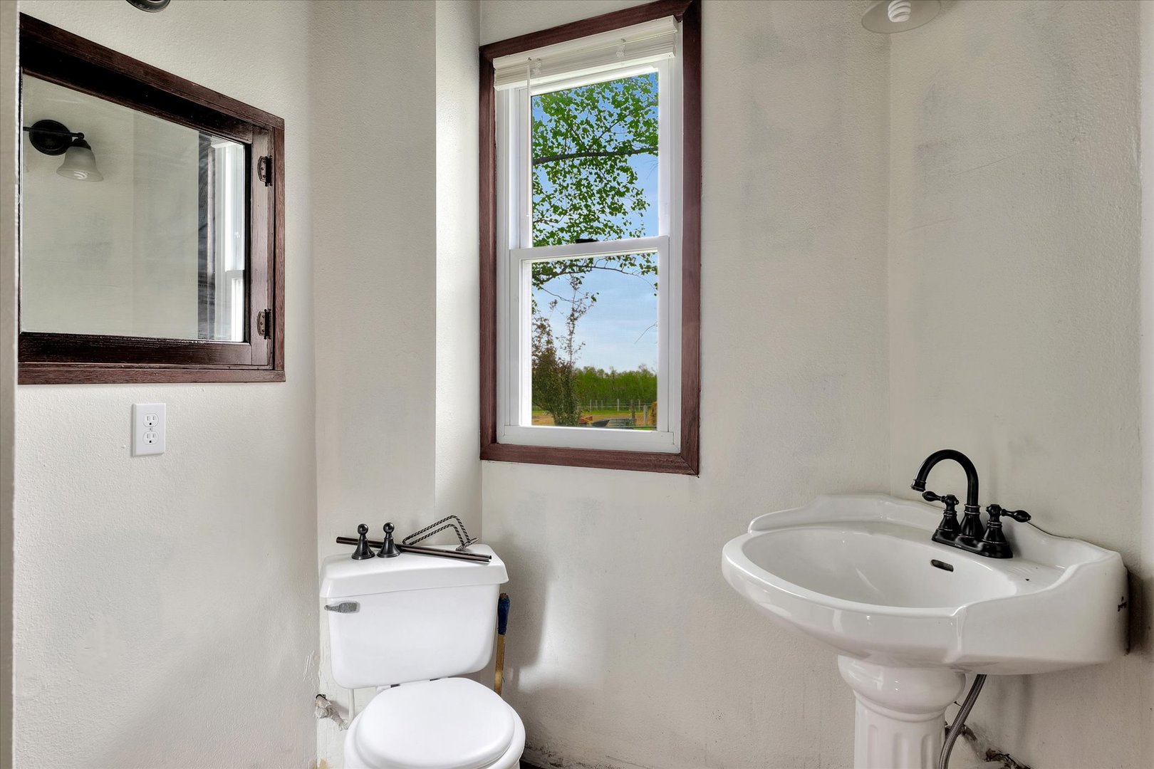 991 Lincoln Hwy Road Lerna, IL 62440 - Photo 17 of 31 a bathroom with a sink and mirror with toilet