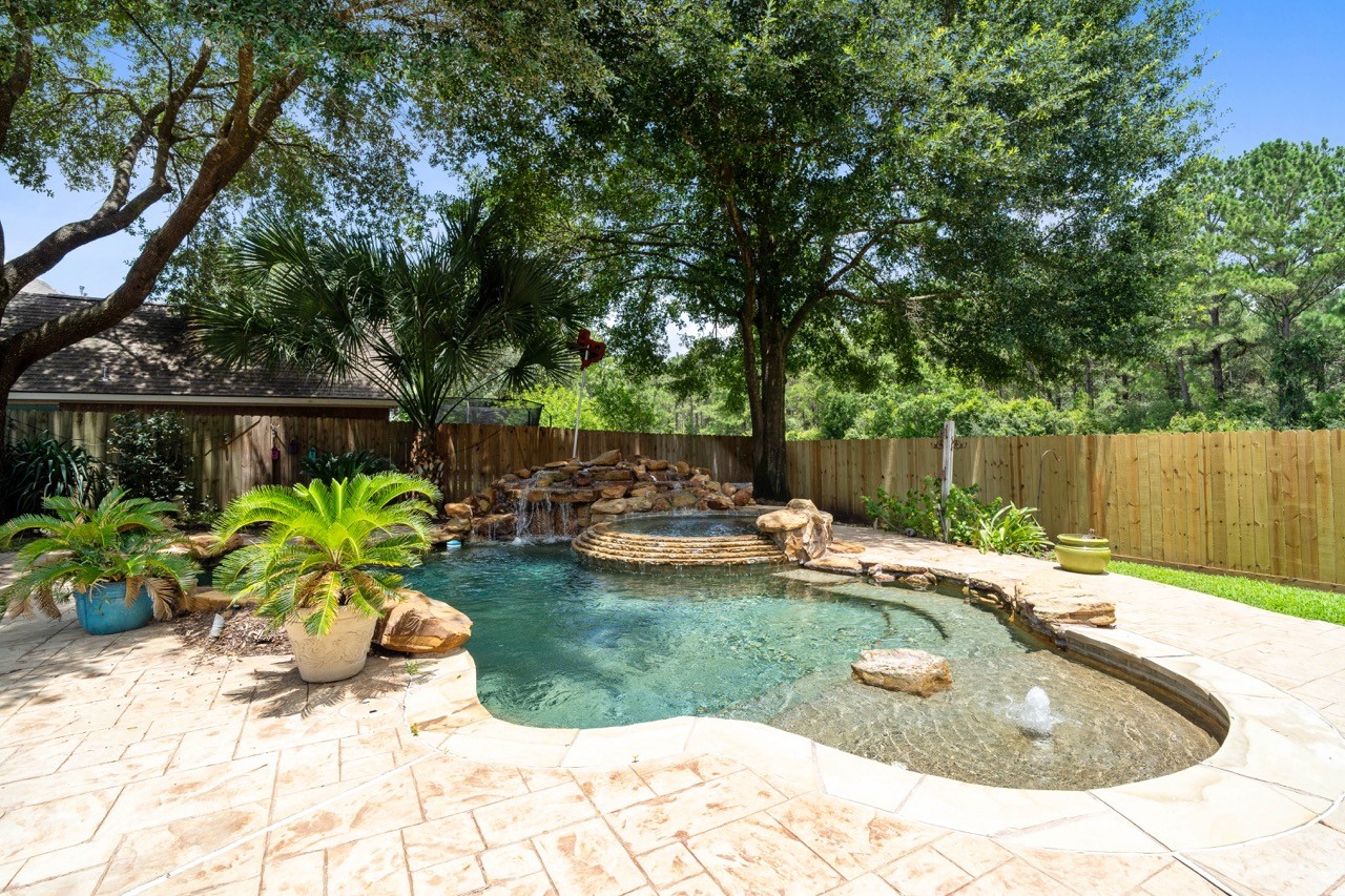 20406 Ranger Point Court Katy, TX 77450 - Photo 43 of 50 Beautiful Pool with Spa, Waterfall, and Sunbathing Deck