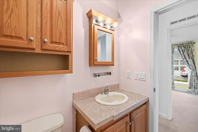 a bathroom with a toilet sink and mirror