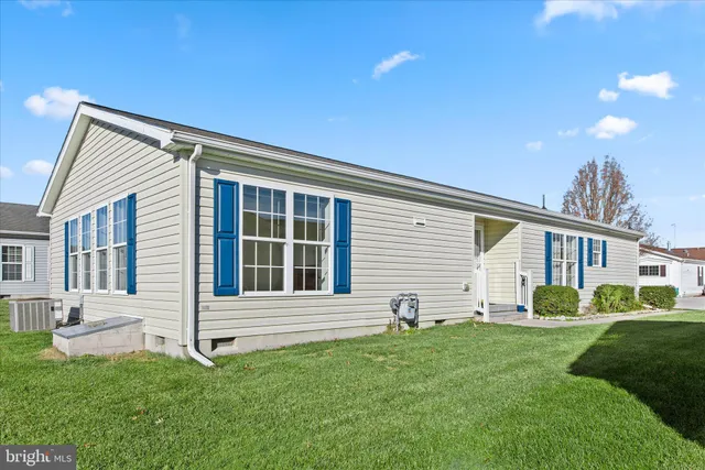 a house view with a sitting space and garden
