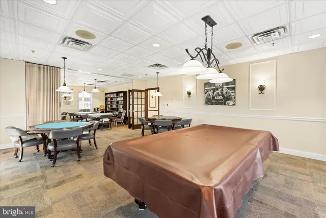 a living room with furniture and a clock