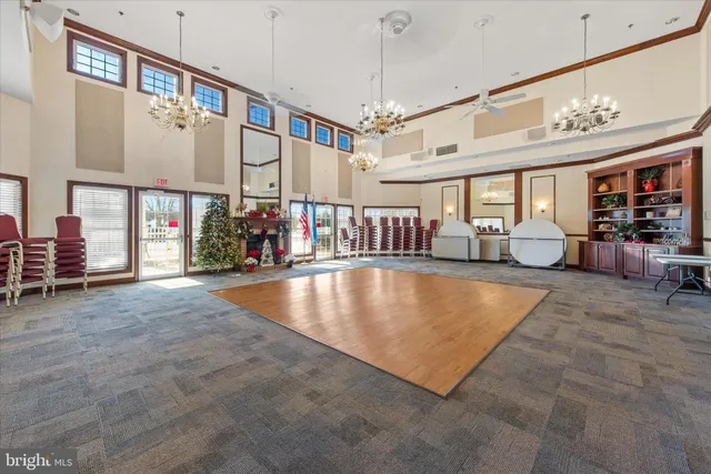 a room with pool table and windows