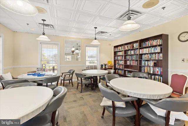 a view of a a dining room with furniture window and wooden floor