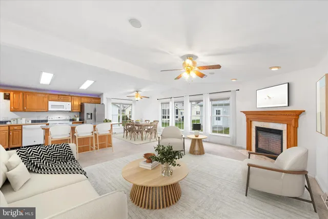 a living room with furniture a fireplace and a table