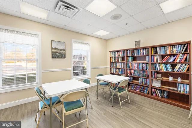 a view of a dining room with furniture and a book shelf