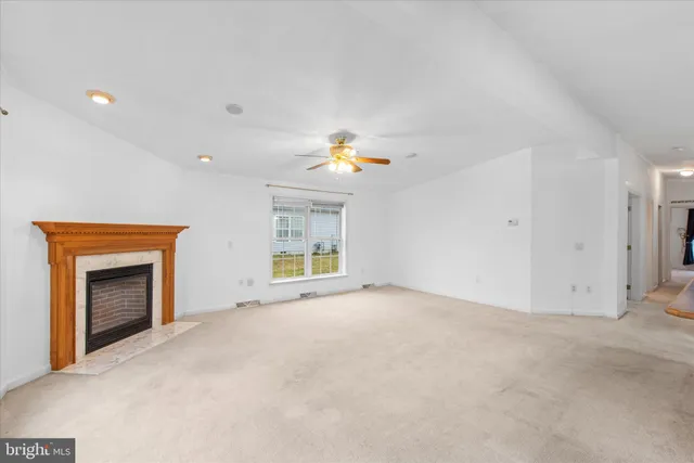a view of empty room with a fireplace