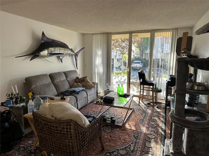 a living room with furniture and a floor to ceiling window