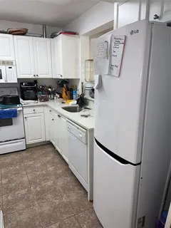 a kitchen with stainless steel appliances a refrigerator sink and cabinets