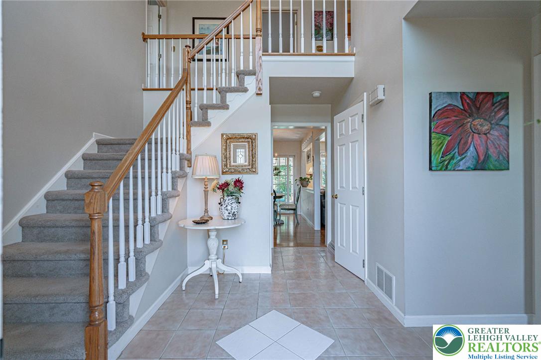 4542 Springfield Drive Coplay, PA 18037 - Photo 8 of 89 A grand two-story entryway welcomes with an elegant staircase and warm, neutral tones.
