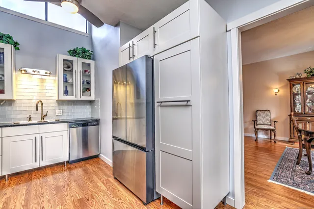 a kitchen with stainless steel appliances granite countertop a refrigerator and a sink