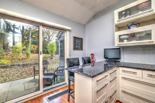 a kitchen with granite countertop a stove and a sink