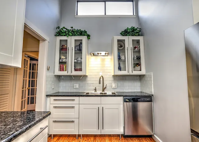 a kitchen with stainless steel appliances granite countertop a stove and a refrigerator