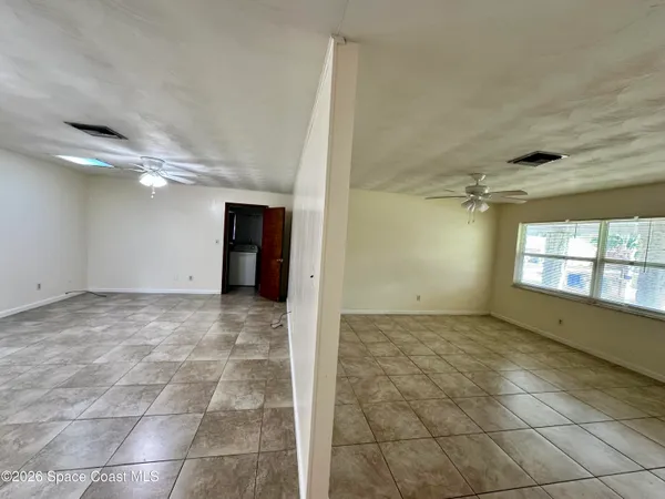 a view of an empty room with a window