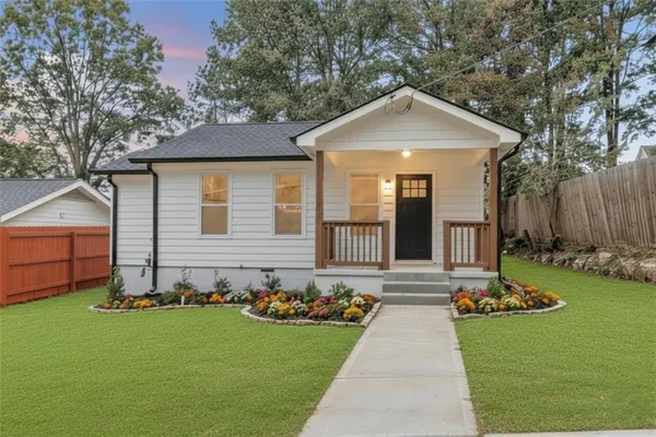 a front view of house with yard and green space