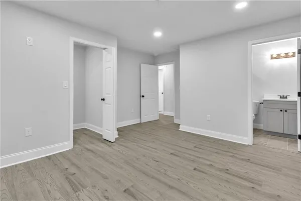 a view of a room with wooden floor and window