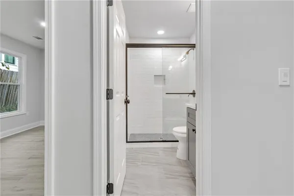a bathroom with a glass shower door