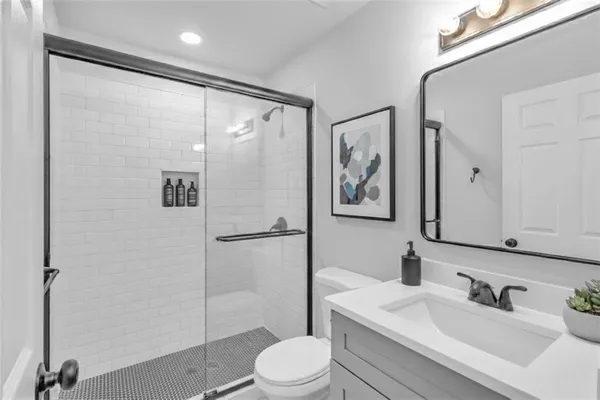 a bathroom with a sink toilet and shower