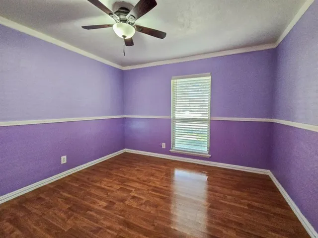 a view of room with window and ceiling fan