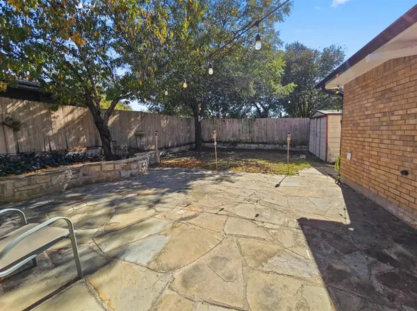 a view of a backyard with large trees